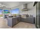 Outdoor kitchen equipped with modern appliances, countertop seating, and a scenic view at 8108 Wild Blue Ter, Sarasota, FL 34241