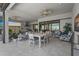 A spacious outdoor living area with a full kitchen, dining table, comfortable seating, and access to the backyard at 8108 Wild Blue Ter, Sarasota, FL 34241