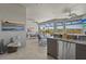 Outdoor living area with views, equipped with a refrigerator, seating and dining areas, and ceiling fans at 8108 Wild Blue Ter, Sarasota, FL 34241