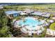 Expansive community pool with palm trees, lounge chairs, and a splash pad offers a luxurious recreational experience at 8108 Wild Blue Ter, Sarasota, FL 34241