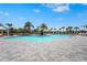 Beautiful community pool featuring plenty of lounge chairs and beautiful landscaping on a sunny day at 8108 Wild Blue Ter, Sarasota, FL 34241