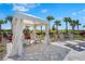 Relaxing pool cabana with comfortable lounge chairs and shaded seating surrounded by lush landscaping and palm trees at 8108 Wild Blue Ter, Sarasota, FL 34241