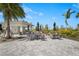 Charming poolside pavilion with plenty of tables, seating, and landscaping on a sunny day at 8108 Wild Blue Ter, Sarasota, FL 34241