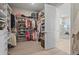 Walk-in closet with custom shelving and storage solutions for organization at 8108 Wild Blue Ter, Sarasota, FL 34241