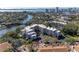 Stunning aerial view of condos surrounded by water and lush greenery, offering a tranquil living experience at 835 S Osprey Ave # 101, Sarasota, FL 34236