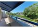 Balcony view of pool, neighborhood and beautiful foliage at 835 S Osprey Ave # 101, Sarasota, FL 34236