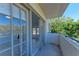 Balcony with large glass doors looking into the home at 835 S Osprey Ave # 101, Sarasota, FL 34236