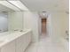Bathroom featuring double sinks, large mirror, and combined shower and bathtub at 835 S Osprey Ave # 101, Sarasota, FL 34236