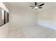 A bright bedroom with white tile floors, a ceiling fan, and a window with blinds at 835 S Osprey Ave # 101, Sarasota, FL 34236