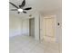 Bedroom with large mirror closet, tiled floor, ceiling fan and a large door opening at 835 S Osprey Ave # 101, Sarasota, FL 34236