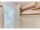Walk-in closet with wooden shelving, with view to hallway and another closet at 835 S Osprey Ave # 101, Sarasota, FL 34236