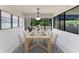 Bright dining room with modern table set and artwork, near sliding glass doors at 835 S Osprey Ave # 101, Sarasota, FL 34236