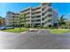 Multi-story condo building featuring open-air staircases, balconies, and lush tropical landscaping at 835 S Osprey Ave # 101, Sarasota, FL 34236