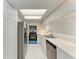Galley kitchen features white cabinetry, stainless appliances, and a skylight at 835 S Osprey Ave # 101, Sarasota, FL 34236