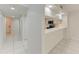 Bright kitchen featuring white cabinetry and tiled floors with a pass-through breakfast bar at 835 S Osprey Ave # 101, Sarasota, FL 34236