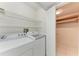Laundry room with white washer and dryer, wire shelving, and doorway to walk-in closet at 835 S Osprey Ave # 101, Sarasota, FL 34236
