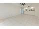 Bright living room with white tile flooring and an open view to the kitchen at 835 S Osprey Ave # 101, Sarasota, FL 34236