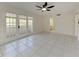 Bright living room with tiled floor, ceiling fan, and access to a patio through glass doors at 835 S Osprey Ave # 101, Sarasota, FL 34236