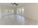 Bright living room with tiled floor, ceiling fan, and access to a patio through glass doors at 835 S Osprey Ave # 101, Sarasota, FL 34236
