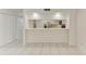 Bright living room with white tile flooring and a partial view to the kitchen at 835 S Osprey Ave # 101, Sarasota, FL 34236