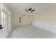 Bright living room with tiled floor, ceiling fan, and access to a hallway through two doorways at 835 S Osprey Ave # 101, Sarasota, FL 34236