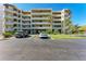 Exterior view of the condo featuring dedicated parking spots and palm trees at 835 S Osprey Ave # 101, Sarasota, FL 34236