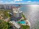 Beautiful aerial view showcasing the beachfront condo, pool, and stunning waterfront at 101 Sunset Dr # 103, Sarasota, FL 34236