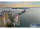 Stunning aerial view of condo building near the beach with a picturesque bay view at sunset at 101 Sunset Dr # 103, Sarasota, FL 34236