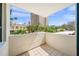 A bright balcony view showcasing the surrounding cityscape with palm trees and architectural charm under a sunny sky at 101 Sunset Dr # 103, Sarasota, FL 34236