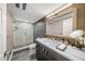 Well-lit bathroom with modern vanity, sleek sink, and glass-enclosed shower for a luxurious experience at 101 Sunset Dr # 103, Sarasota, FL 34236