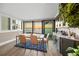 Bright dining area featuring water views, modern decor and adjacent to a built-in bar with marble counters at 101 Sunset Dr # 103, Sarasota, FL 34236