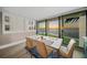 Bright dining room featuring floor-to-ceiling windows with a scenic waterfront view and modern decor at 101 Sunset Dr # 103, Sarasota, FL 34236