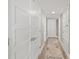 Inviting hallway with clean white doors and a stylish runner leading to various rooms in the home at 101 Sunset Dr # 103, Sarasota, FL 34236