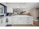 Spacious kitchen with sleek white cabinetry, blue backsplash, and countertops at 101 Sunset Dr # 103, Sarasota, FL 34236