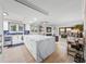 Bright, open kitchen with a large marble island and views of the open-concept living room at 101 Sunset Dr # 103, Sarasota, FL 34236