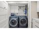 Convenient laundry room featuring modern washer and dryer, storage cabinets, and countertop at 101 Sunset Dr # 103, Sarasota, FL 34236