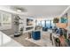 Cozy living room featuring a fireplace, coastal decor, and floor-to-ceiling windows with water views at 101 Sunset Dr # 103, Sarasota, FL 34236