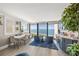 Bright and airy living room with Gulf views, modern finishes, and built in bar for entertaining at 101 Sunset Dr # 103, Sarasota, FL 34236
