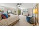 Spacious main bedroom boasts a ceiling fan, balcony access, and calming decor for a relaxing retreat at 101 Sunset Dr # 103, Sarasota, FL 34236