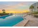 Stunning waterfront pool area offering lounge chairs, umbrellas, and beautiful sunset views at 101 Sunset Dr # 103, Sarasota, FL 34236