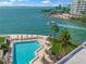 Scenic waterfront pool area with bay views, palm trees, and outdoor seating for relaxation at 101 Sunset Dr # 103, Sarasota, FL 34236