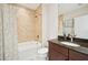 Bathroom featuring bathtub with shower and dark wooden sink at 10530 Boardwalk Loop # 201, Lakewood Ranch, FL 34202