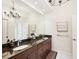 Bathroom features double vanity, elegant lighting, and a large mirror to enhance the sense of space at 10530 Boardwalk Loop # 201, Lakewood Ranch, FL 34202