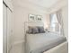 Cozy bedroom with a queen sized bed and bright window with curtain at 10530 Boardwalk Loop # 201, Lakewood Ranch, FL 34202