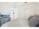 View of a bedroom featuring a large bed and TV at 10530 Boardwalk Loop # 201, Lakewood Ranch, FL 34202