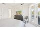 Bright bedroom with a modern dresser, access to a balcony, and neutral tones at 10530 Boardwalk Loop # 201, Lakewood Ranch, FL 34202