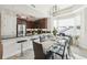 The dining room showcases a glass table and chairs next to a breakfast bar with a stainless steel refrigerator at 10530 Boardwalk Loop # 201, Lakewood Ranch, FL 34202