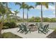 Inviting outdoor fire pit with seating, set among lush landscaping and palm trees, perfect for relaxing evenings at 10530 Boardwalk Loop # 201, Lakewood Ranch, FL 34202