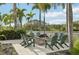 Inviting outdoor fire pit with seating, set among lush landscaping and palm trees, perfect for relaxing evenings at 10530 Boardwalk Loop # 201, Lakewood Ranch, FL 34202