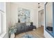 Stylishly decorated foyer features attractive console table with decor items, mirror and abstract artwork on the wall at 10530 Boardwalk Loop # 201, Lakewood Ranch, FL 34202